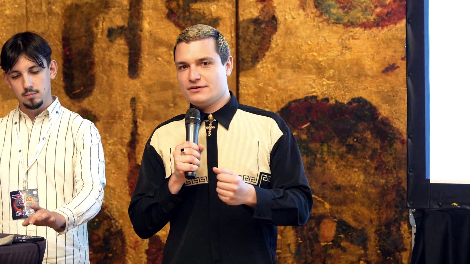A speaker with a microphone at a past edition