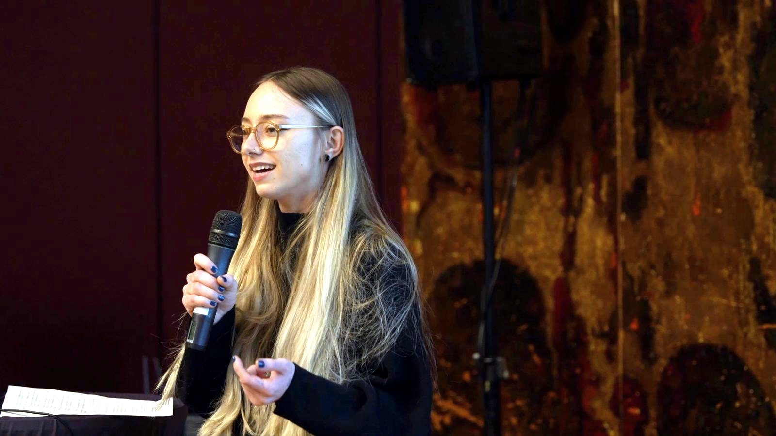 A participant presenting with a microphone